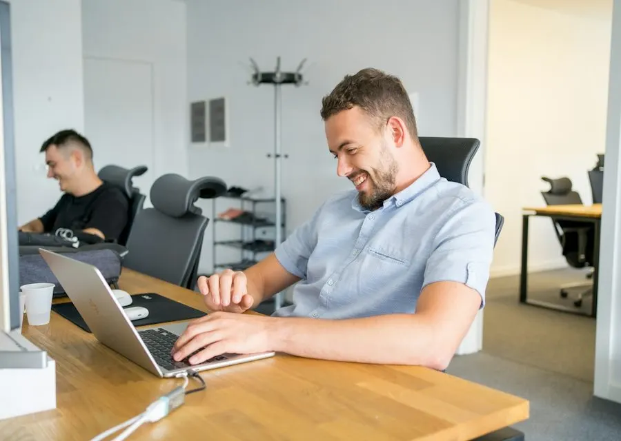Colleagues working at laptops in a bright office